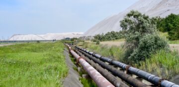 Tubing on the edge of a salt mine going into the distance